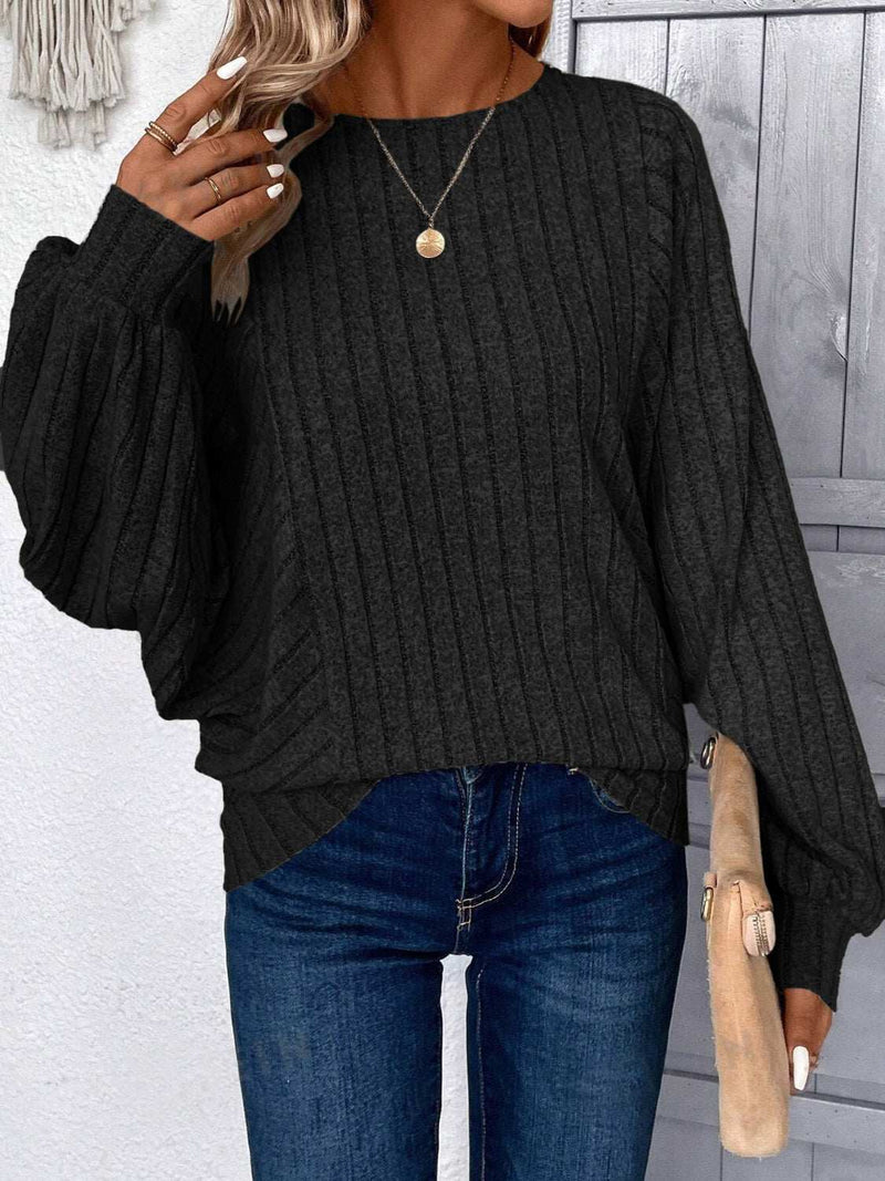 Plus size round neck batwing sleeve t-shirt, black, paired with jeans.