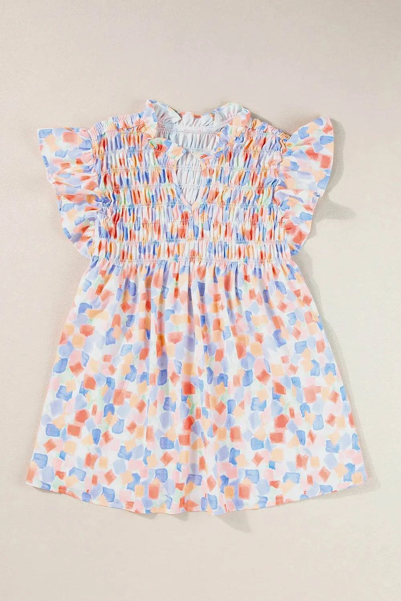 Ruffled printed notched cap sleeve blouse in pastel colors.