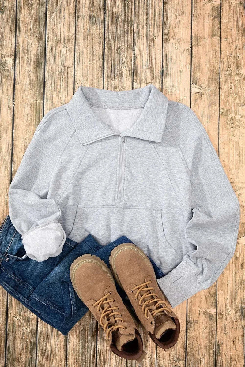 Half Zip Long Sleeve Sweatshirt on wooden floor with jeans and boots.