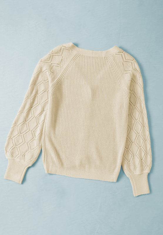Openwork V-neck button-up cardigan with lace sleeves on a blue background.