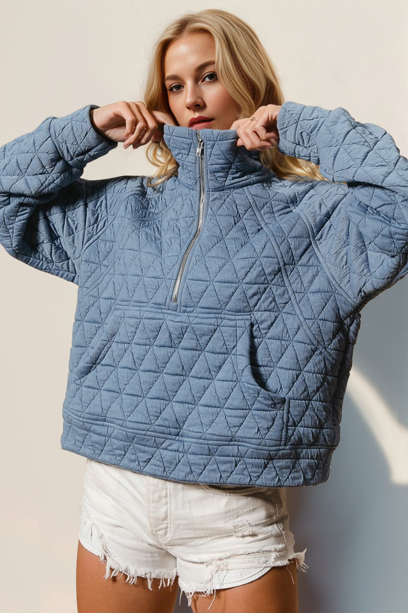 Blue half zip long sleeve quilted sweatshirt with pocket.