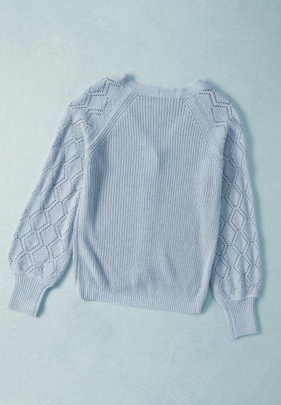 Openwork V-neck button-up cardigan in light blue with patterned sleeves.
