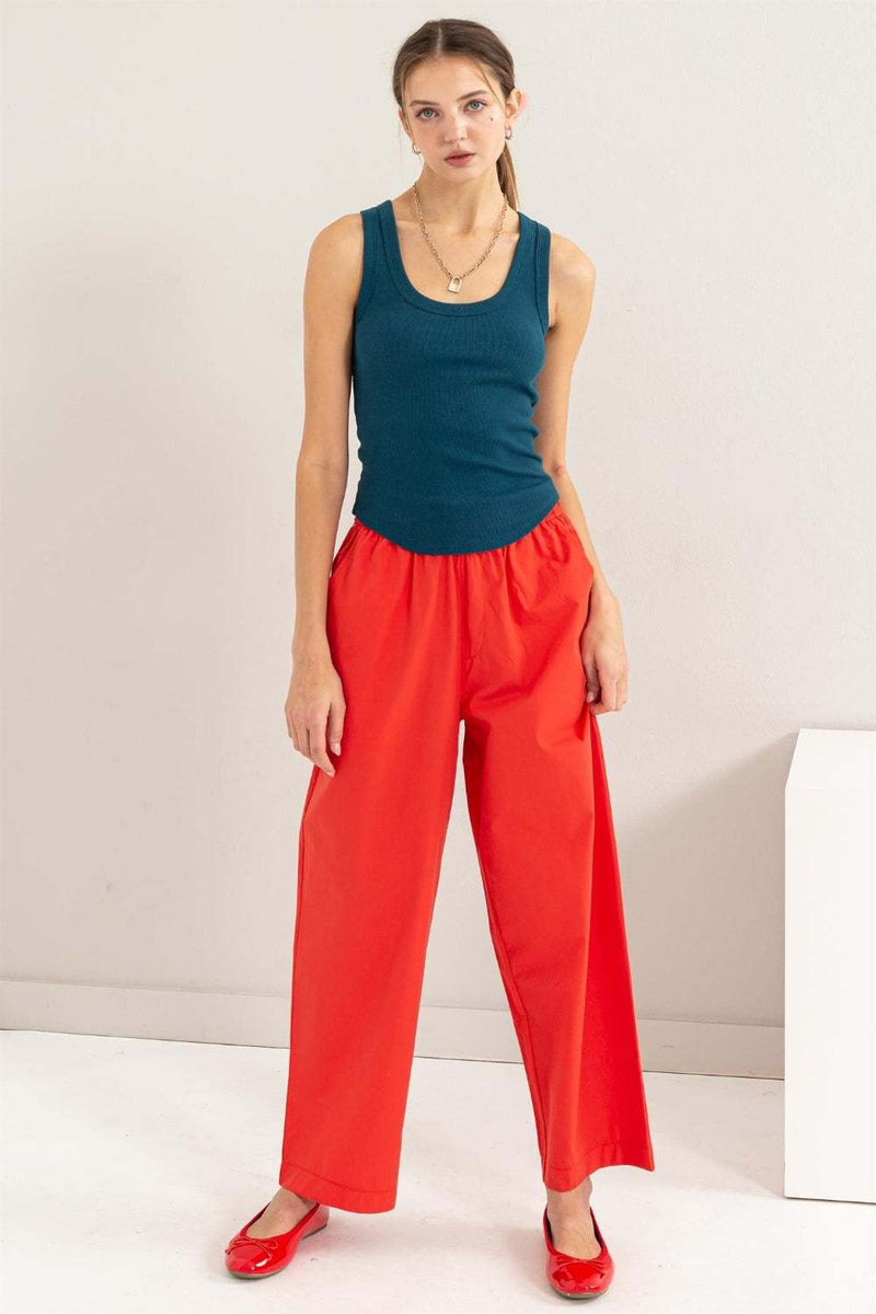 HYFVE Ribbed Scoop Neck Racerback Tank in teal, styled with red pants and shoes.