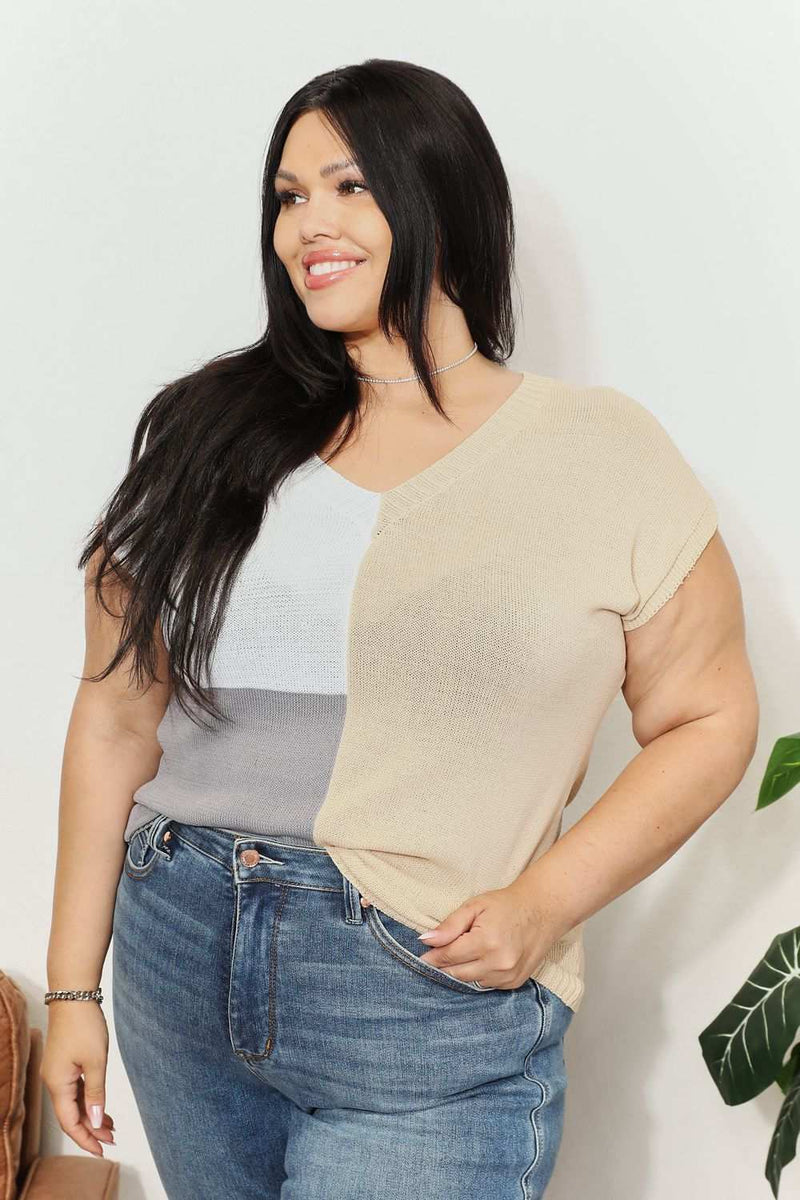 Color block V-neck knit top with short sleeves and a stylish design, worn by a model.