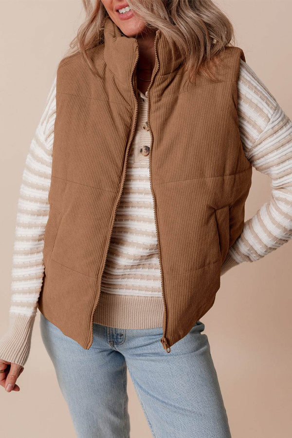 Coffee Corduroy Stand Neck Zipped Puffer Vest on a person with striped sweater and jeans.