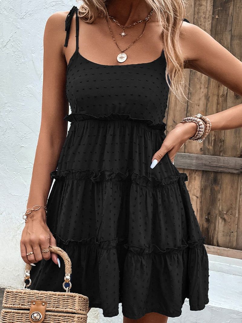 Shiny frill spaghetti strap tiered dress in black polyester with no stretch.