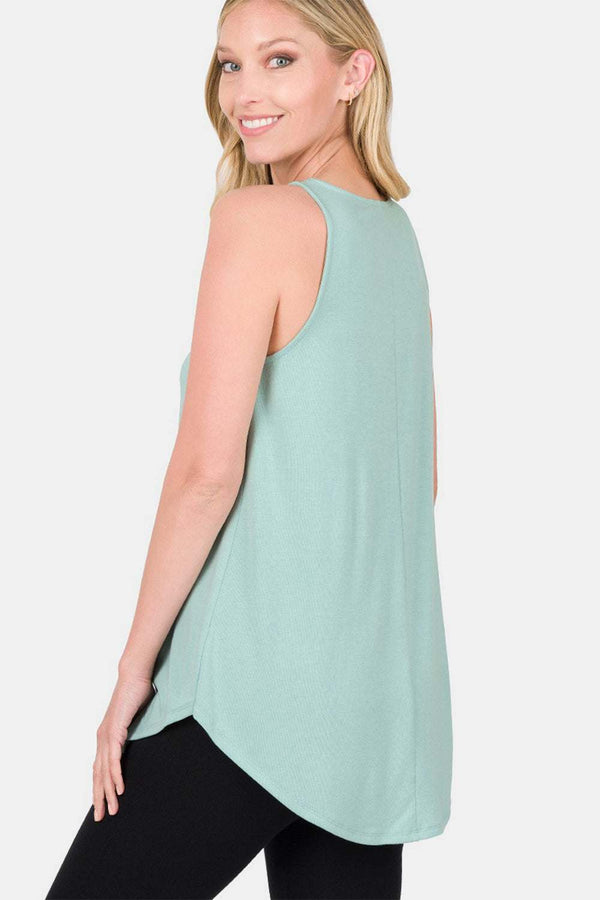 Woman wearing Zenana Round Neck Curved Hem Tank in light green, featuring a classic round neck and curved hem, ideal for casual wear.