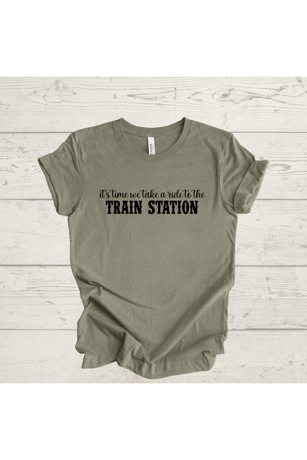 Green t-shirt with "It's Time to Take a Ride to the Train Station" text.