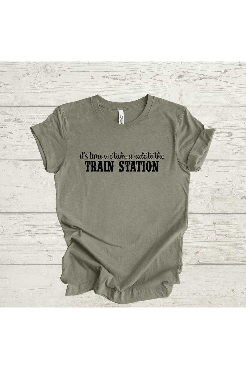 Green t-shirt with "It's Time to Take a Ride to the Train Station" text.