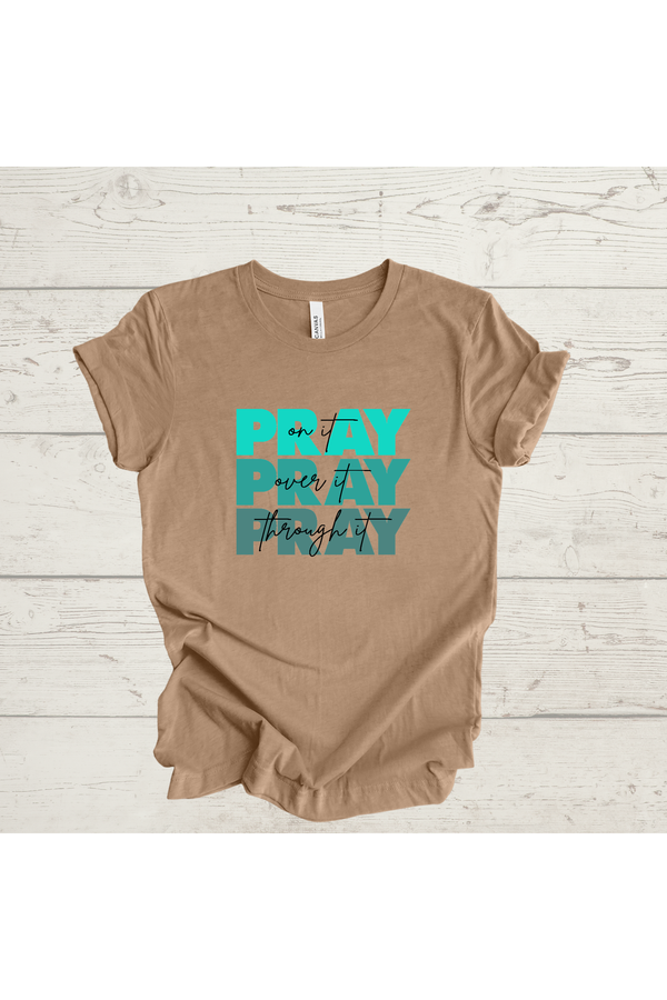 Beige t-shirt with "Pray On it, Over it, Through it" text.