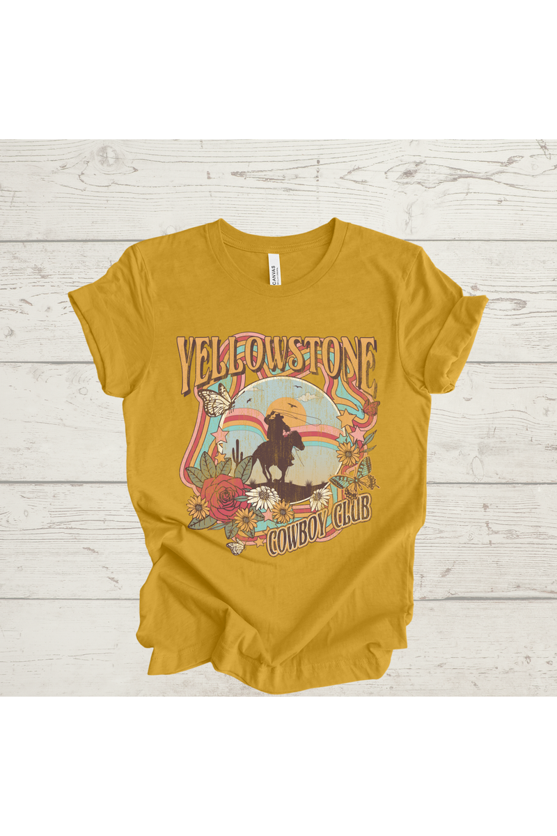 Yellowstone Cowboy Club graphic t-shirt on light wood background.