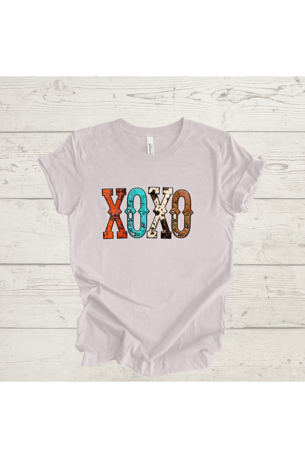 XOXO Western Print Graphic Tee on a wooden surface