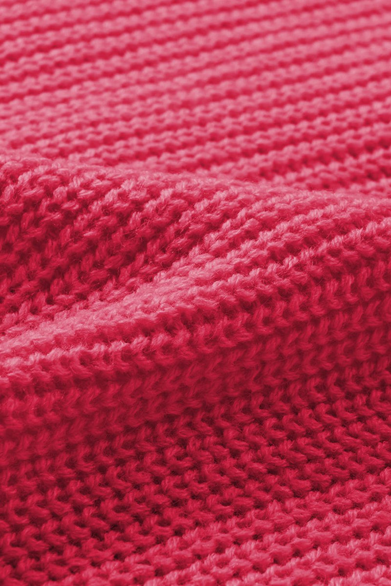 Close-up of openwork V-neck button-up cardigan fabric texture in pink.