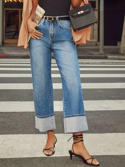 High waisted straight leg rolled jeans with buttoned pockets in blue.