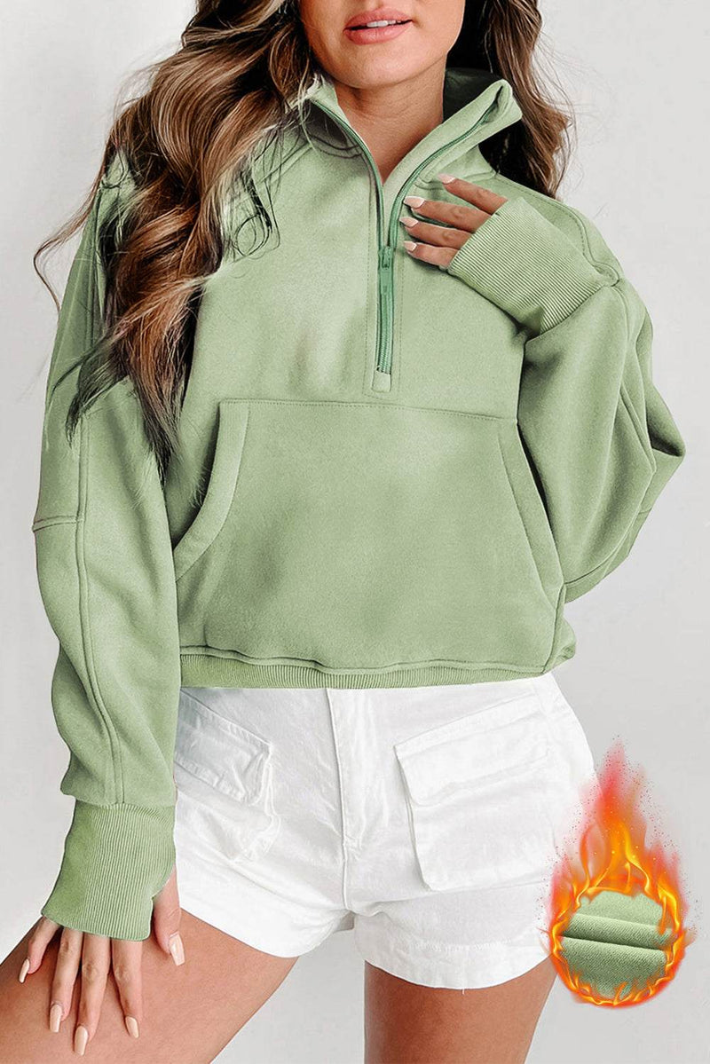Fleece lined zip up stand collar thumbhole sleeve sweatshirt in green.