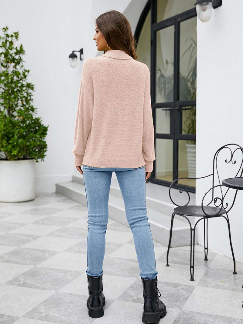 Woman wearing Turtleneck Dropped Shoulder Sweater, beige color, paired with jeans and black boots, standing outdoors.