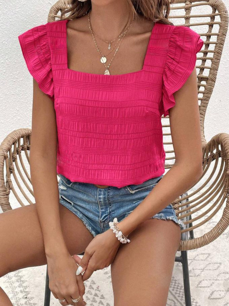 Ruffled square neck cap sleeve blouse in vibrant pink with textured fabric.