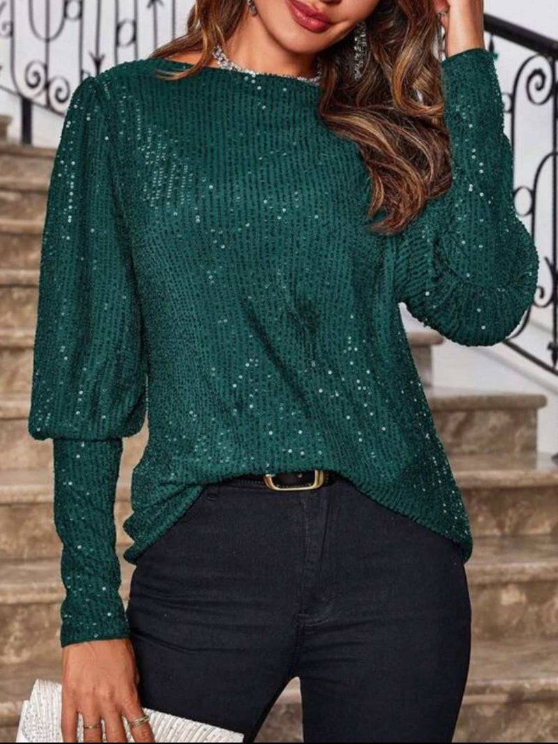 Sequin boat neck long sleeve top in dark green worn by a woman.