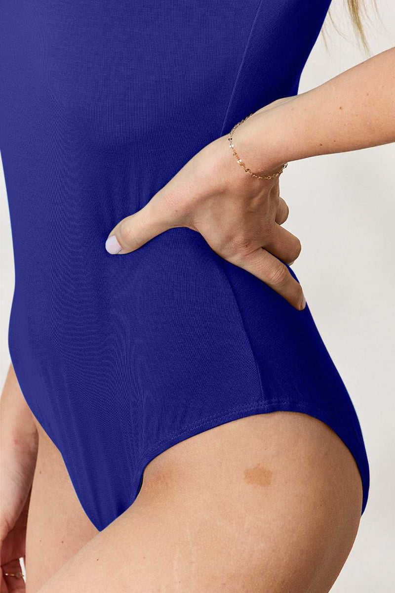Basic Bae full size round neck short sleeve bodysuit in blue, highlighting moderate stretch and fit.