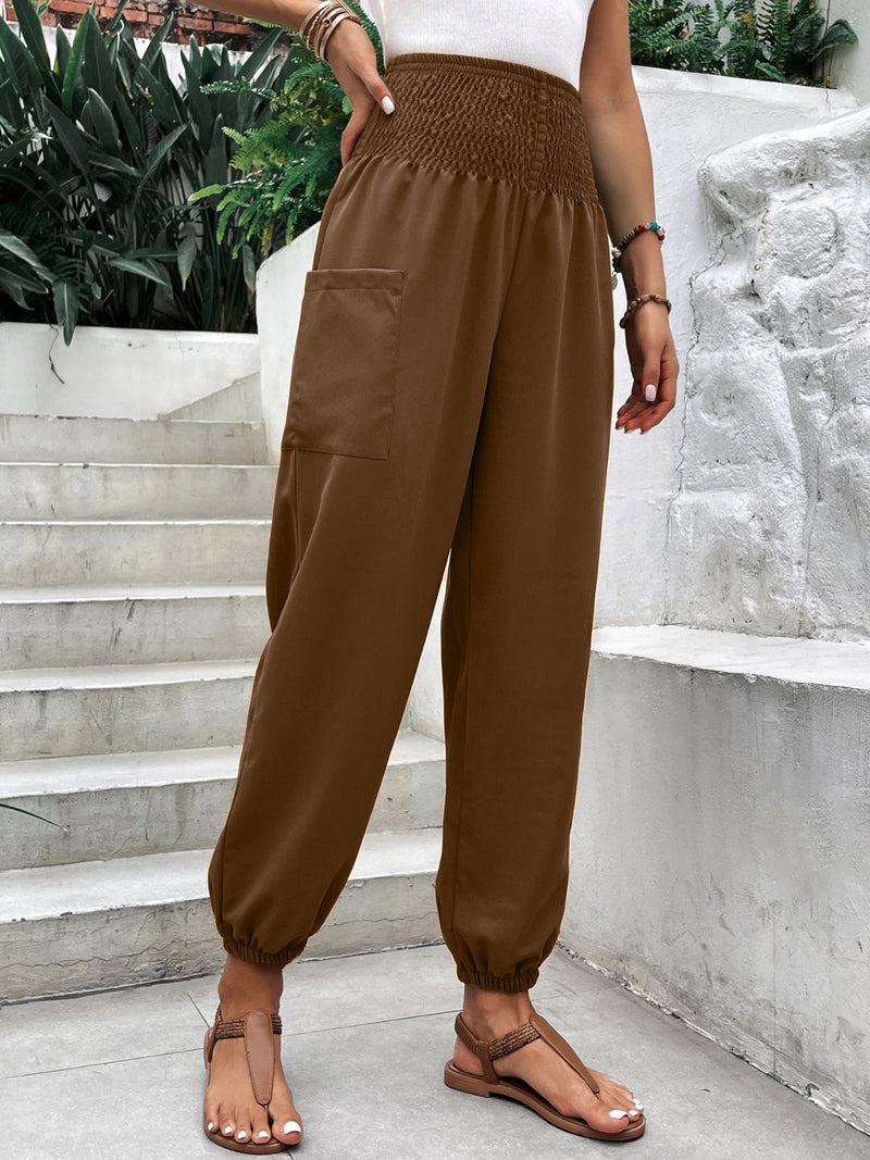 Smocked high rise joggers with pockets in brown, basic style, worn by a model outdoors.