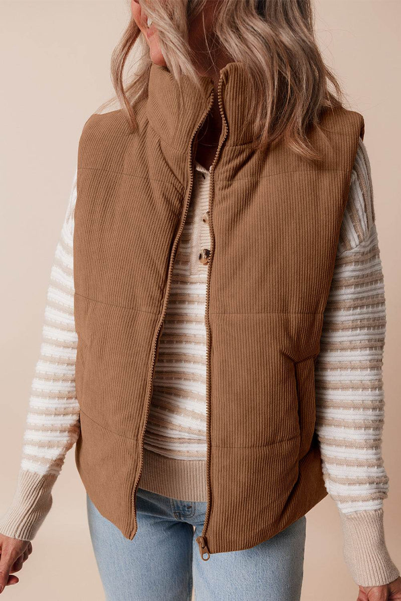 Coffee Corduroy Stand Neck Zipped Puffer Vest with striped sweater underneath.