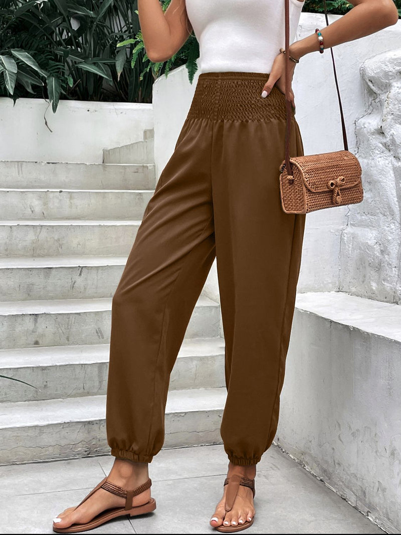 Smocked high rise joggers with pockets in brown, featuring a relaxed fit.