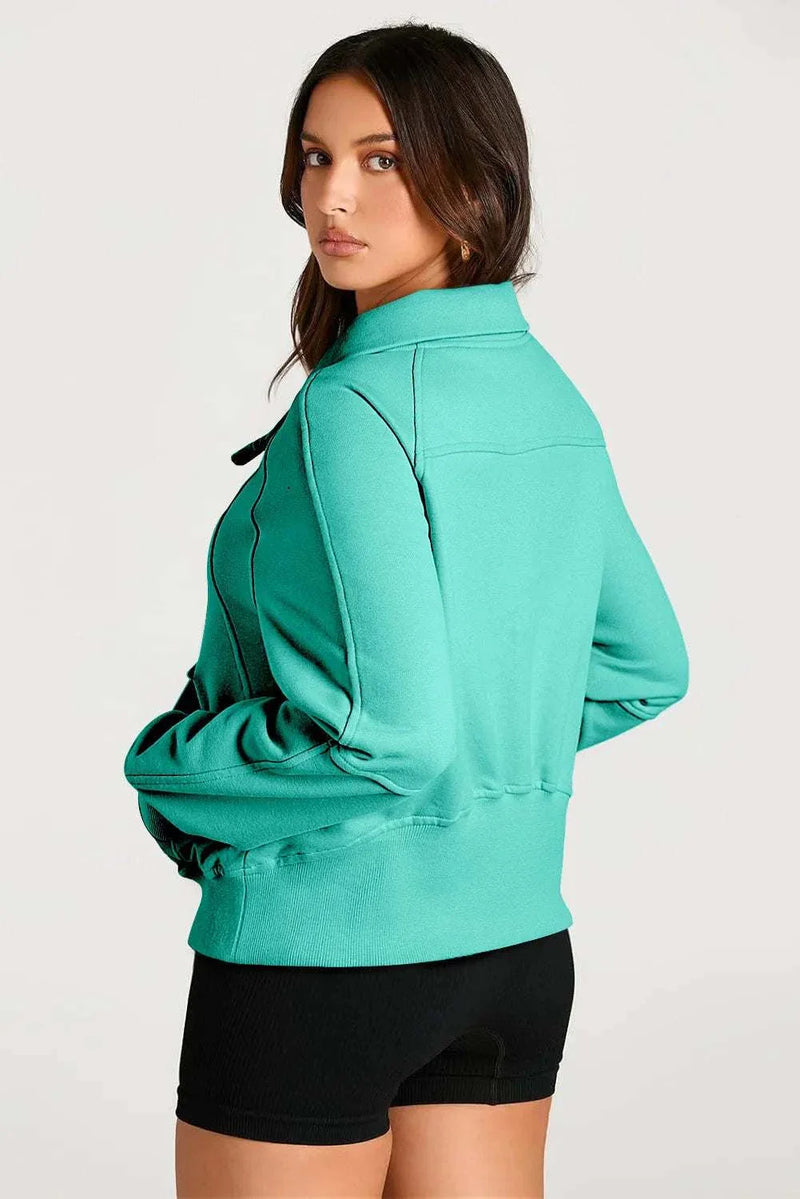 Half Zip Long Sleeve Sweatshirt in teal, worn by a model, showcasing modern style and comfort.