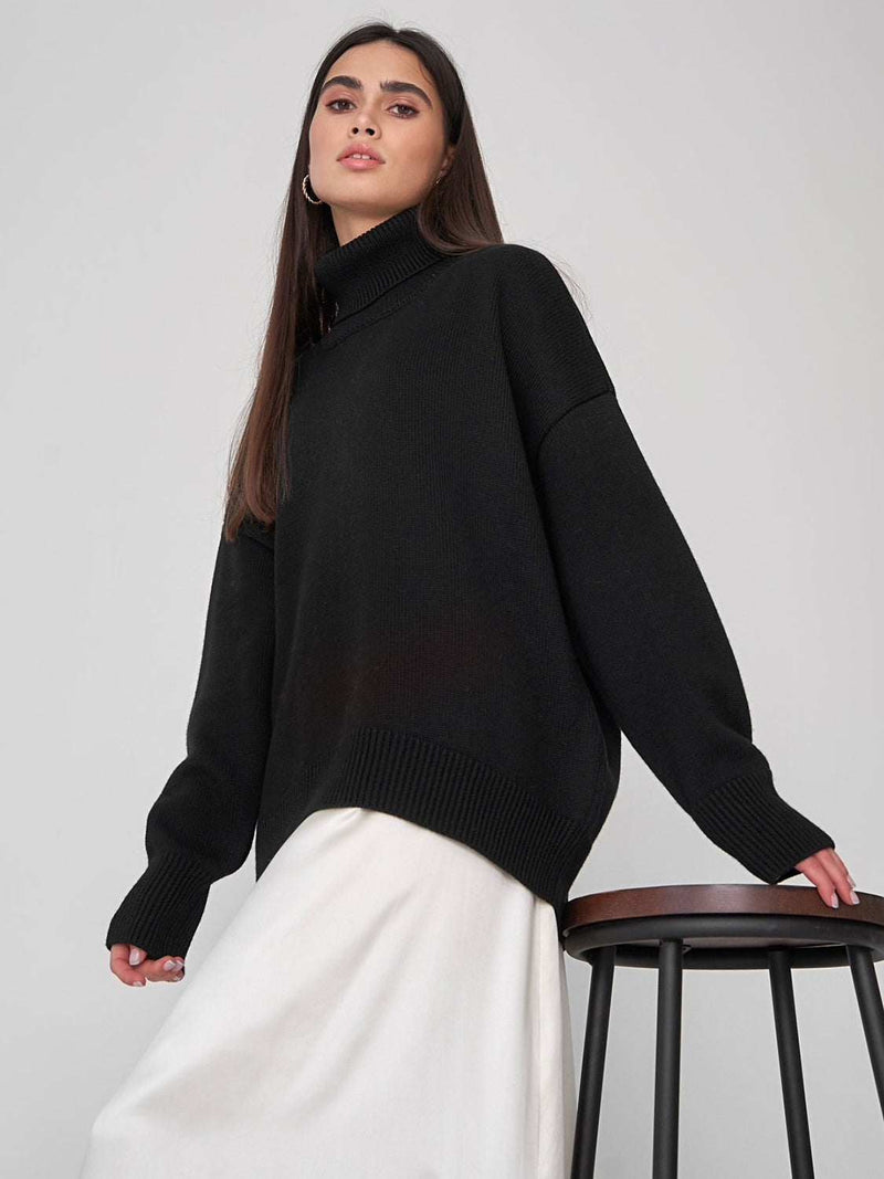 Black turtleneck long sleeve sweater with slight stretch.