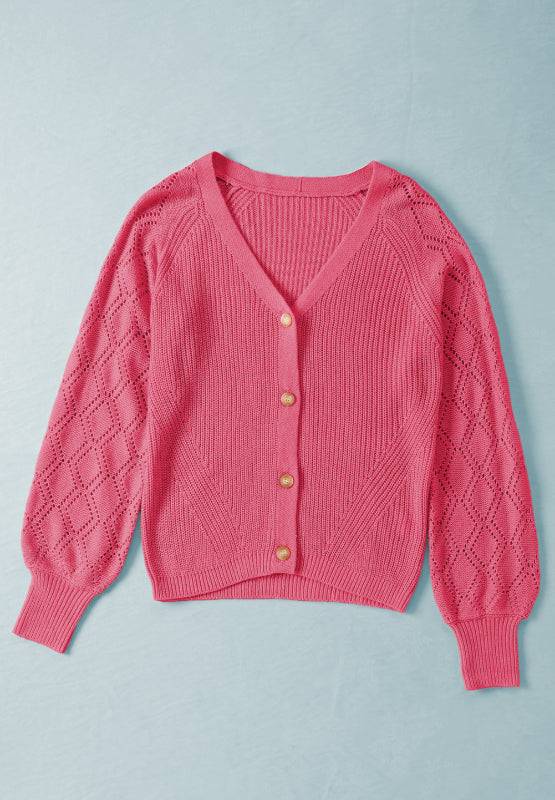 Openwork V-neck button-up pink cardigan made of slightly stretchy acrylic material.