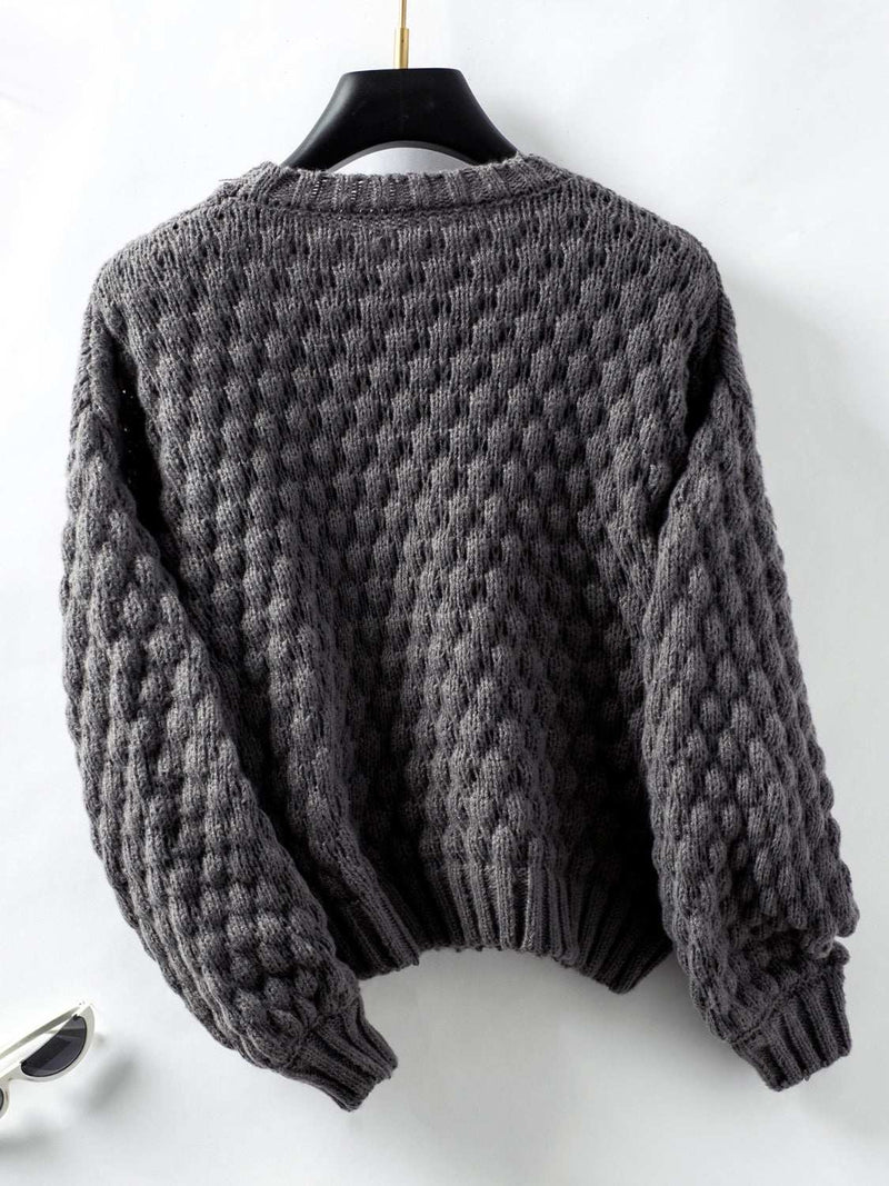 Cable-Knit Round Neck Long Sleeve Sweater with textured design.