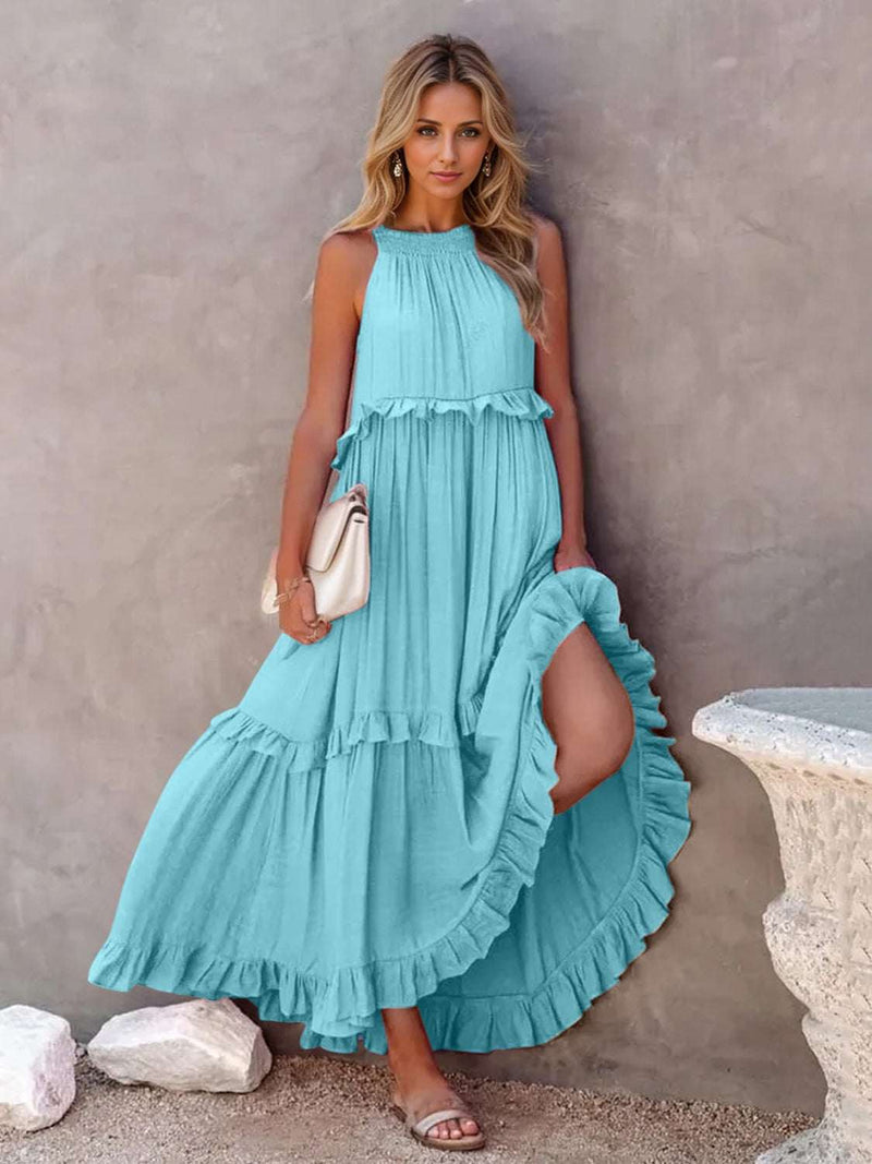 Ruffled sleeveless tiered maxi dress with pockets in blue, features tied high-low and smocked design.