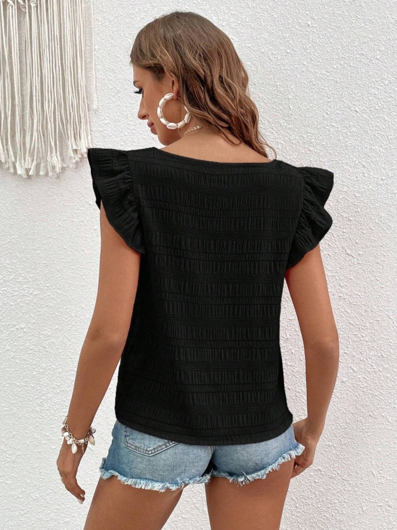 Ruffled square neck cap sleeve blouse in black fabric, shown from the back with ruffle details.