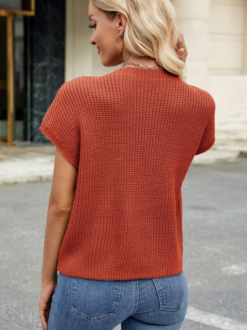 Round neck short sleeve sweater in rust color, pocketed and slightly stretchy, 100% acrylic.