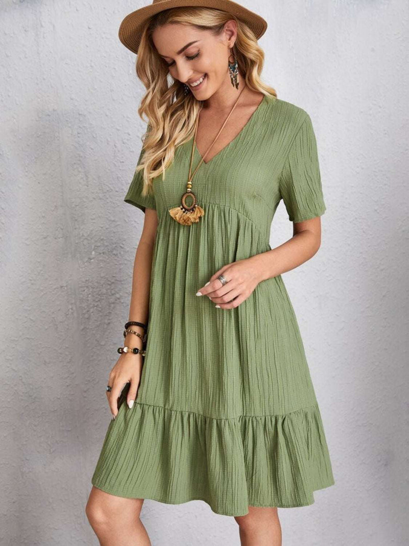Full size green V-neck short sleeve dress in polyester fabric.