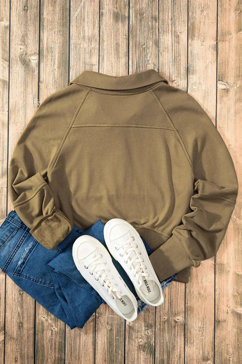 Half Zip Long Sleeve Sweatshirt in brown, paired with jeans and white sneakers on wooden floor.