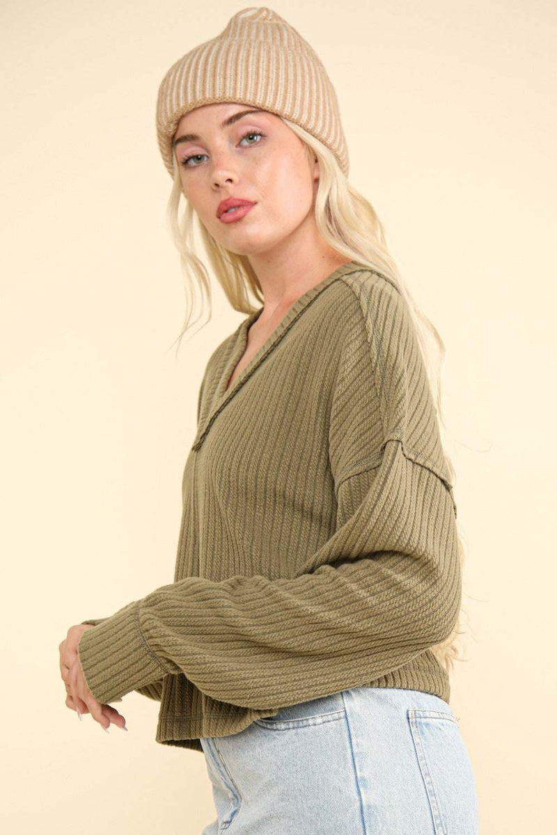 V-neck ribbed knit top with exposed seams and drop shoulder design.