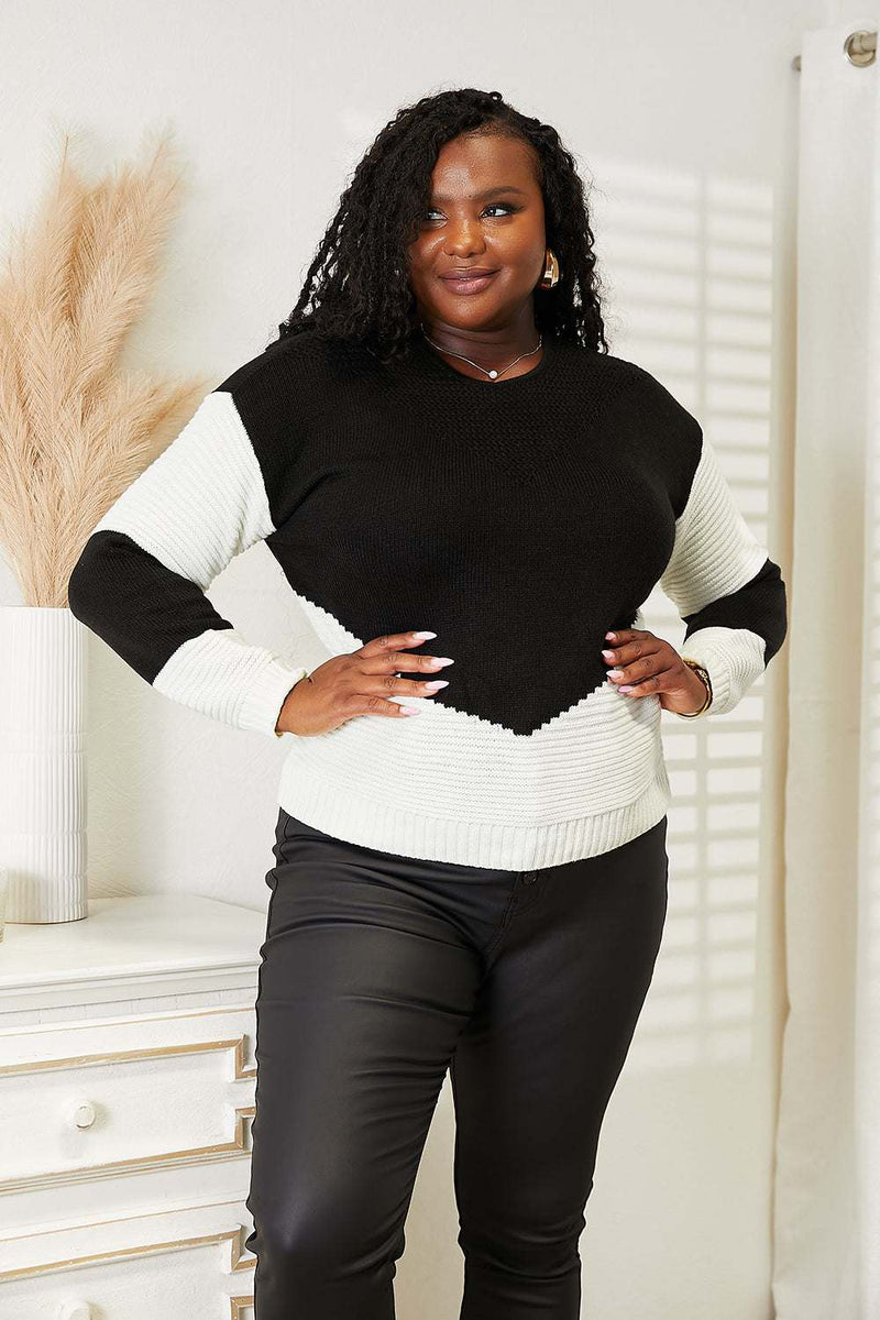 Two-tone openwork rib-knit sweater with round neckline and long sleeves.