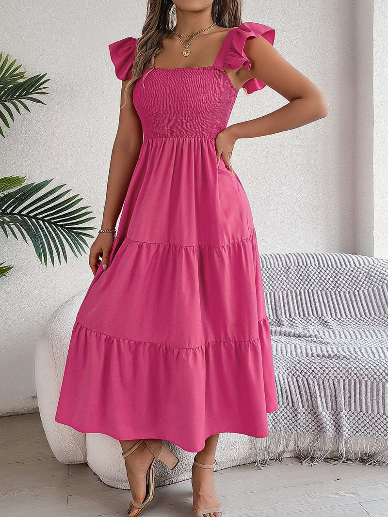 Smocked square neck cap sleeve midi dress in pink fabric with tiered skirt.