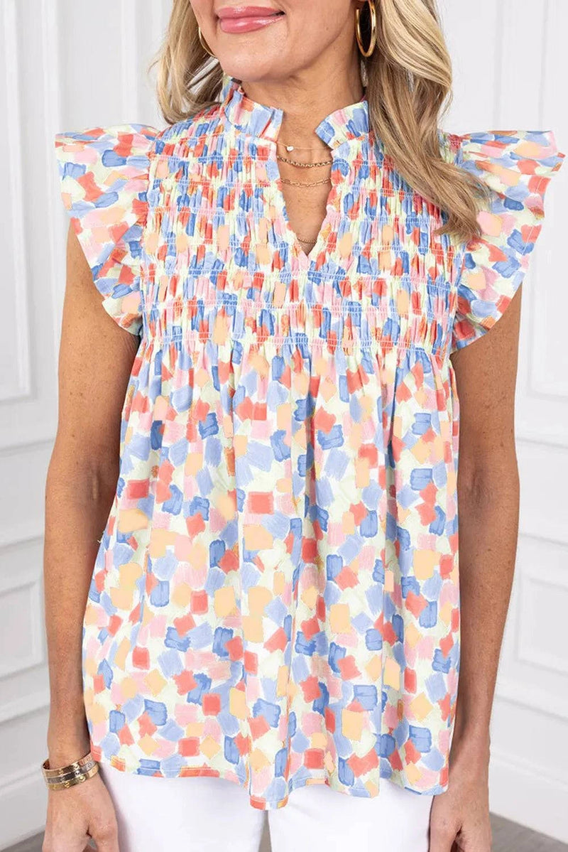 Ruffled printed notched cap sleeve blouse in colorful pattern.