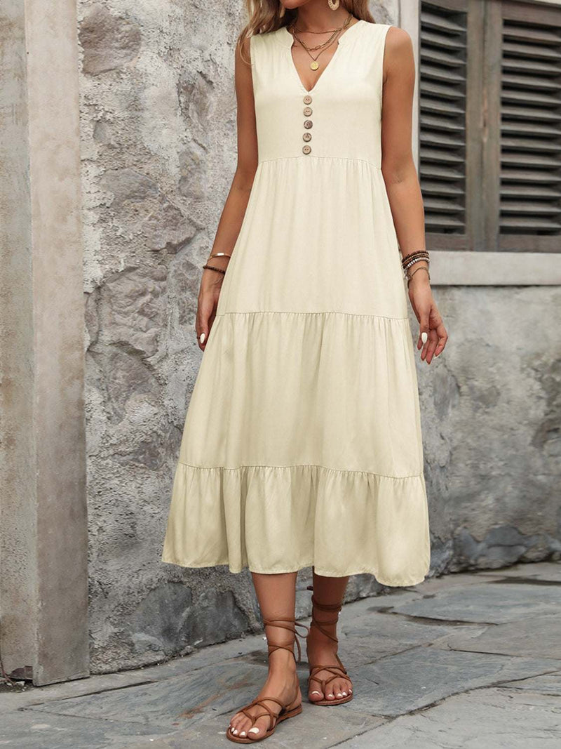 Ivy Lane Decorative Button Notched Sleeveless Dress in cream with a tiered skirt, shown outdoors.