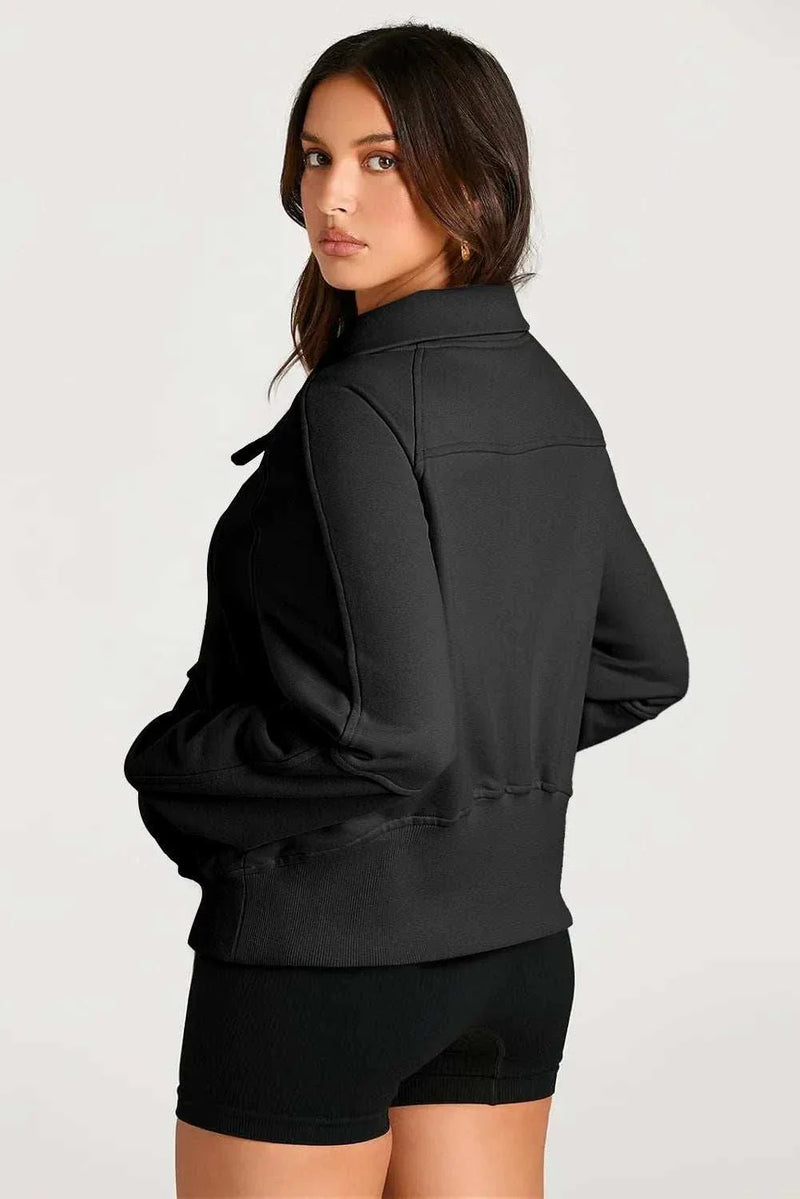 Woman wearing black Half Zip Long Sleeve Sweatshirt from back view.