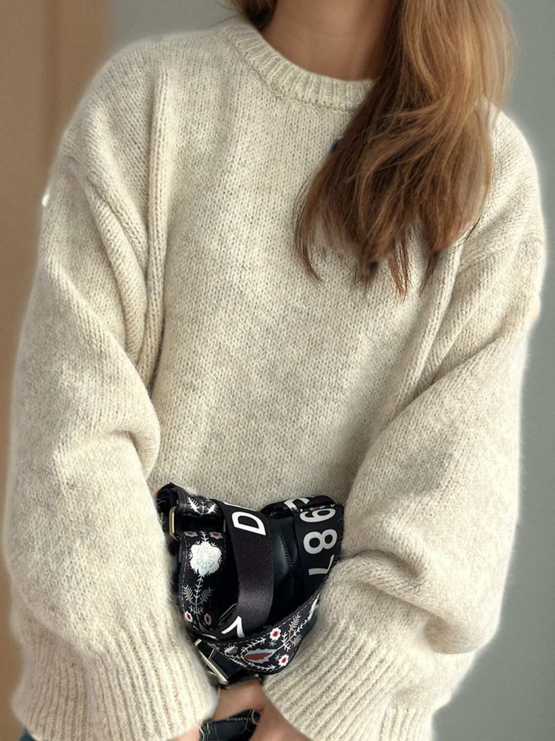 Round neck long sleeve sweater in beige, offering warmth and classic style.