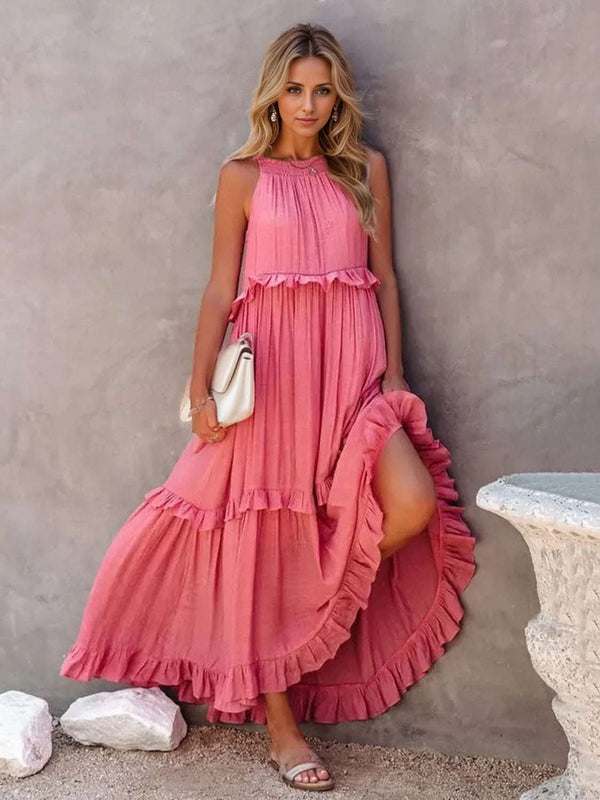 Ruffled sleeveless tiered maxi dress with pockets, high-low hem, and smocked details.