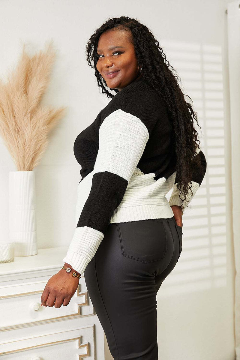 Two-tone rib-knit sweater with openwork design and long sleeves.