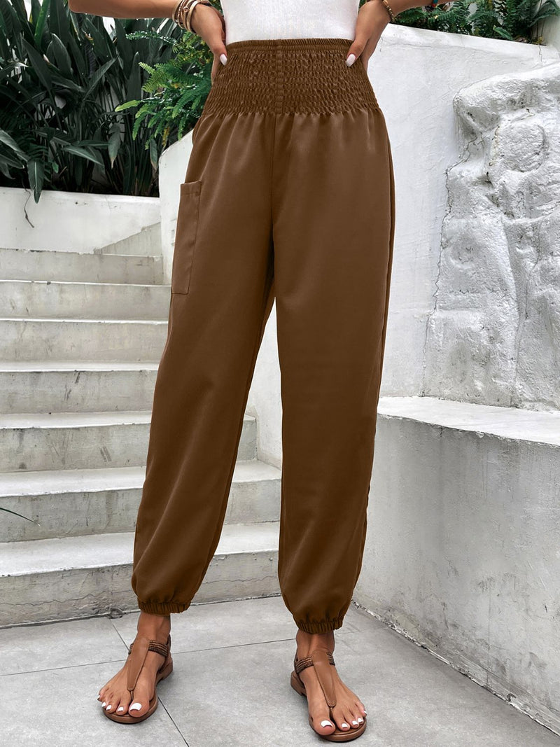 Smocked high rise joggers with pockets, brown, polyester-spandex blend.