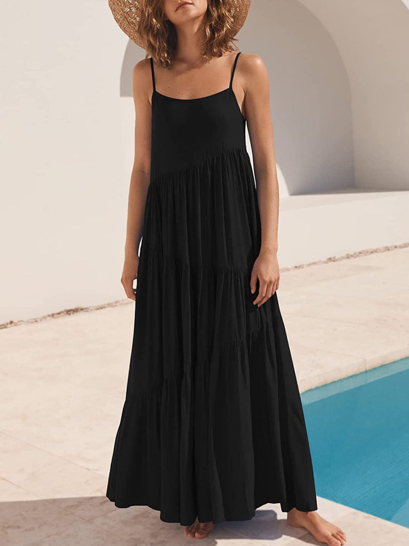Full Size Ruched Tiered Spaghetti Strap Dress in black by the pool.