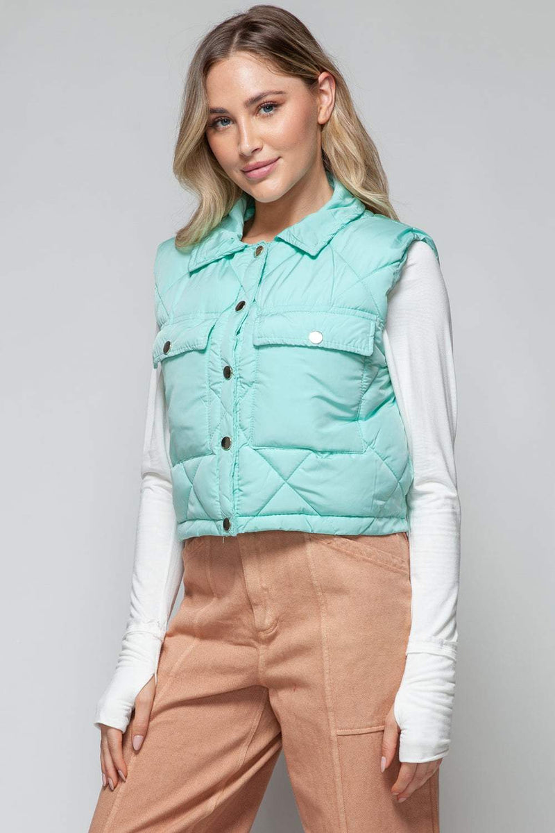 Snobbish Snap Down Quilted Crop VestThe snap-down quilted crop vest is a stylish and versatile addition to your wardrobe. With its snap-button closure and cropped length, this vest offers a modern and OuterwareTrendsiKlondike Creek Unique BoutiqueQuilted Crop Vest
