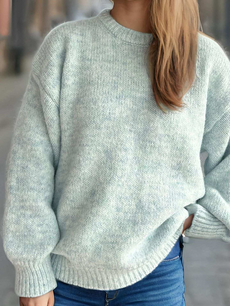 Round neck long sleeve sweater in light blue, styled with jeans.