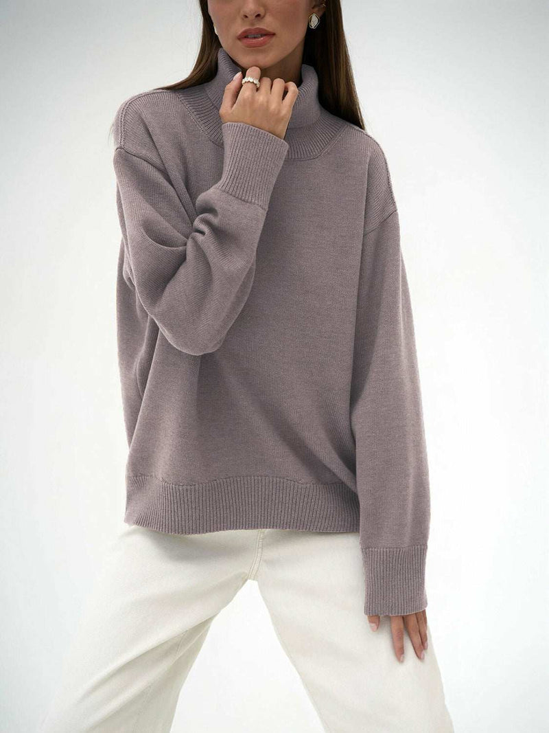 Turtleneck long sleeve sweater in soft gray with ribbed cuffs and hem, slightly stretchy material.