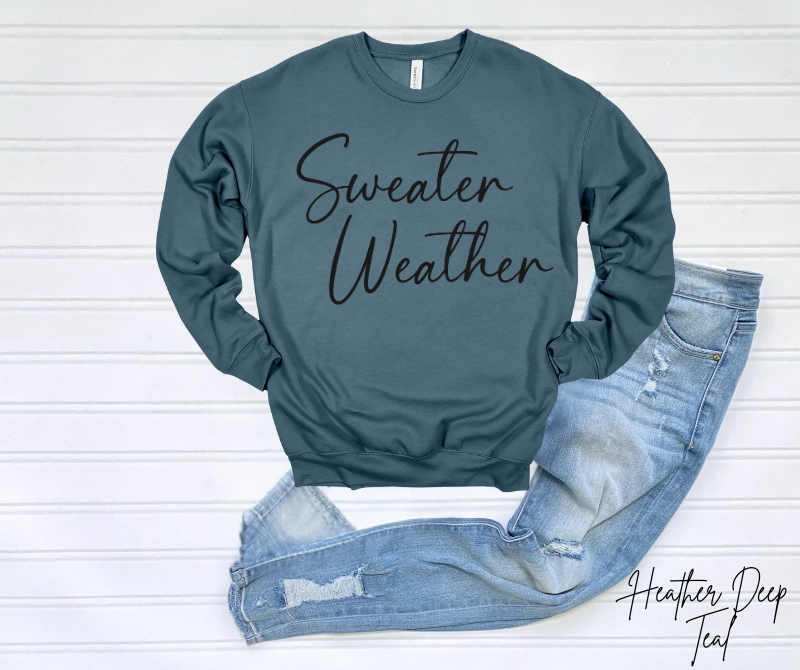 Sweater Weather Sweatshirt in blue with "Sweater Weather" text, paired with distressed jeans.